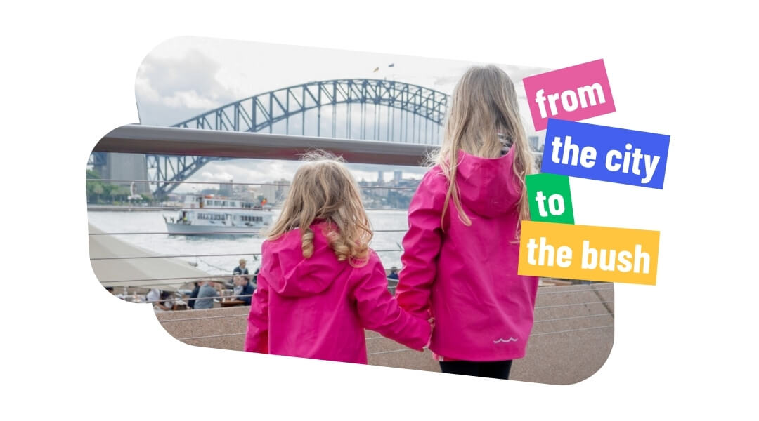 Girls in pink raincoast looking at Sydney Harbour Bridge