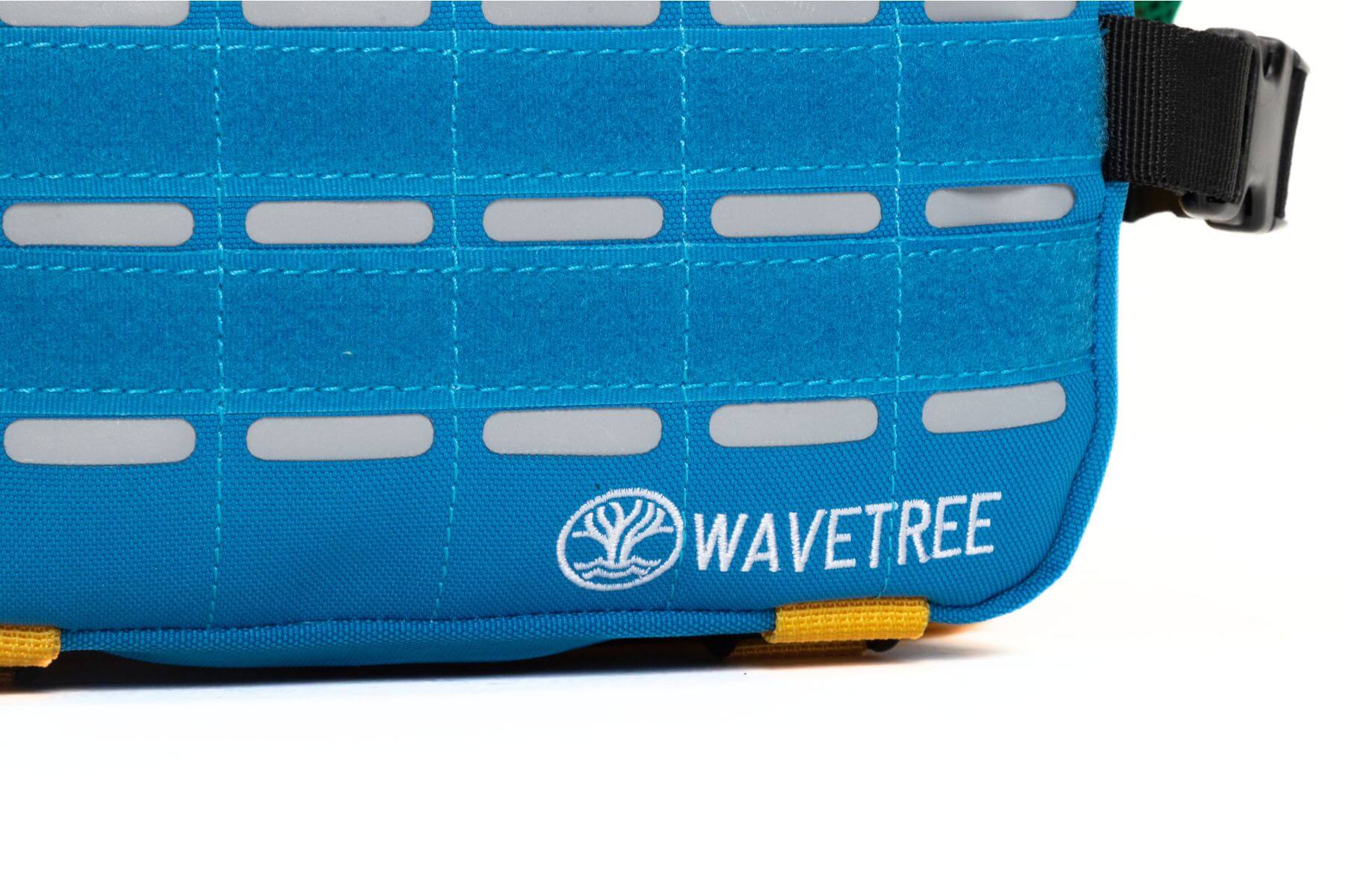 Wavetree backpack close up of logo, reflective grey strips and blue velcro