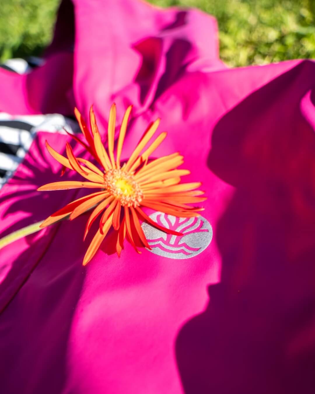 Pink raincoat with a orange flower