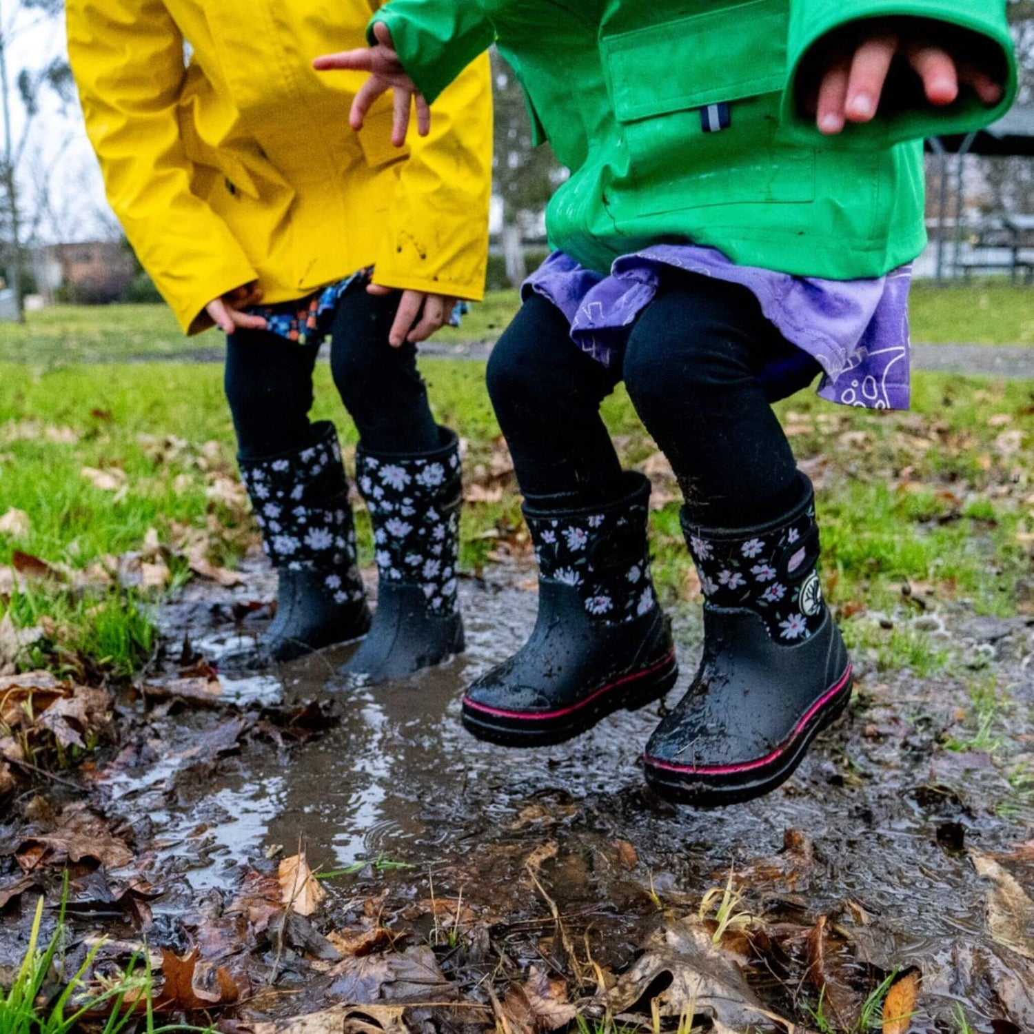 Kids jumping in muddy puddle wearing Wavetree rainwear