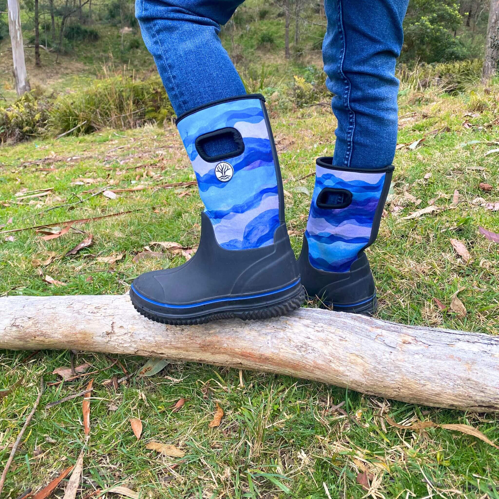Child wearing Blue Neosoft Boots in garden
