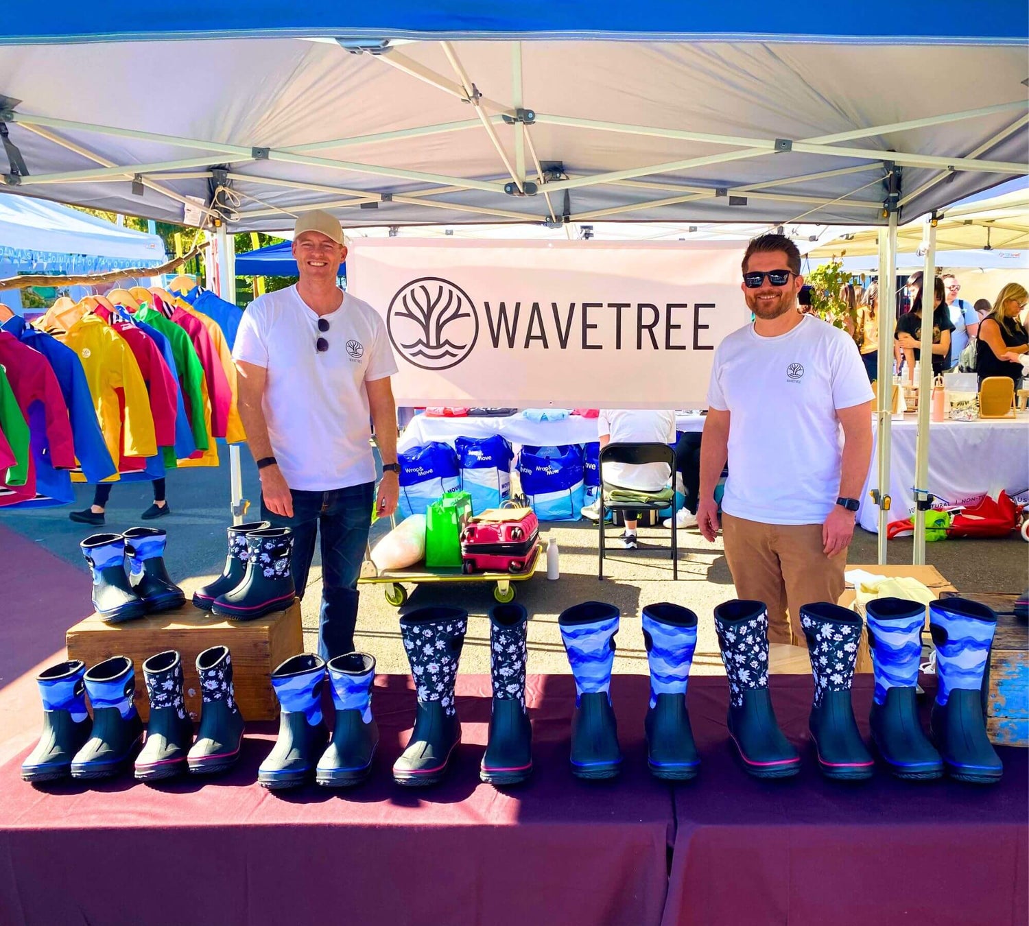 Wavetree founders at a market stall with colourful raincoats and gumboots