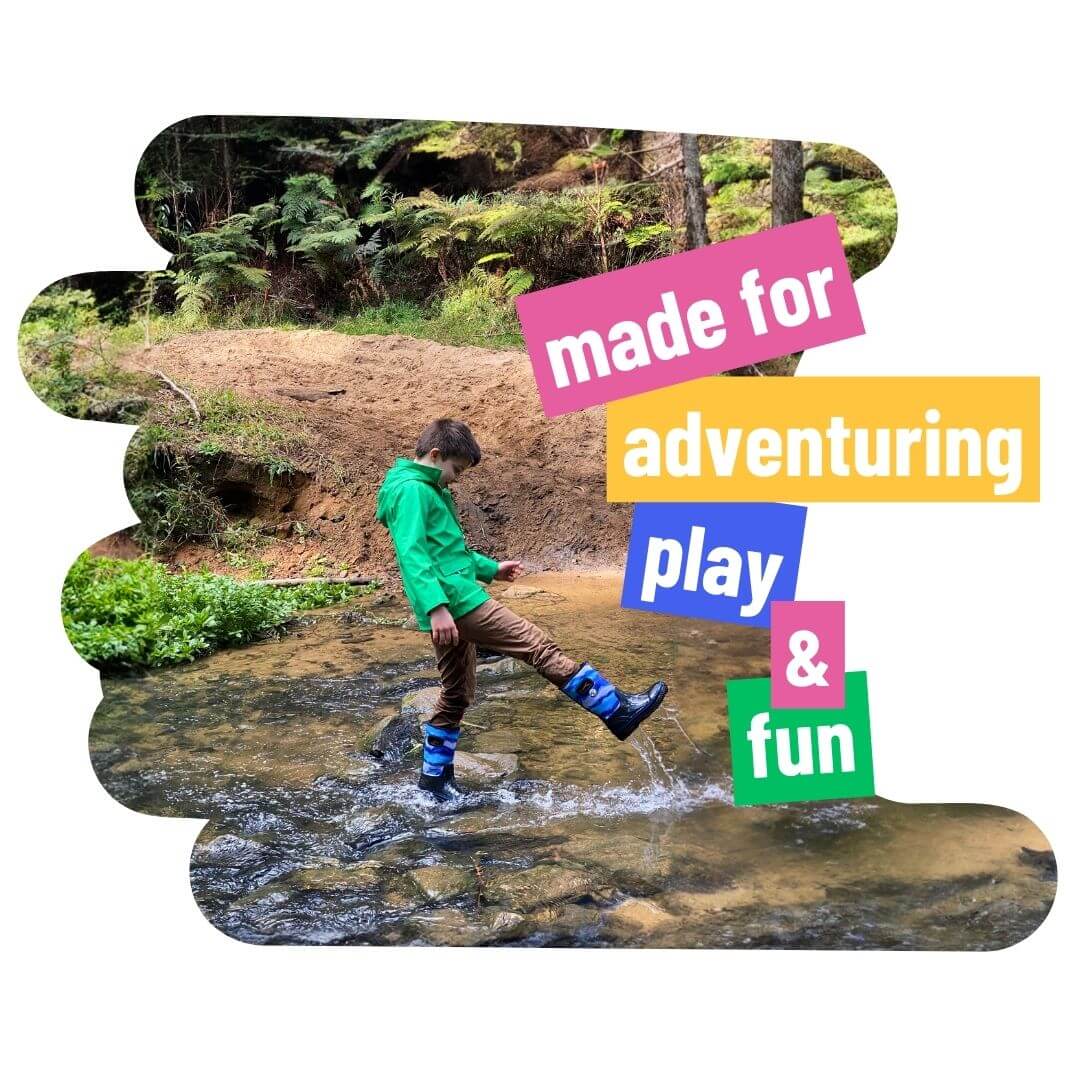 Boy playing in stream wearing Wavetree rainwear