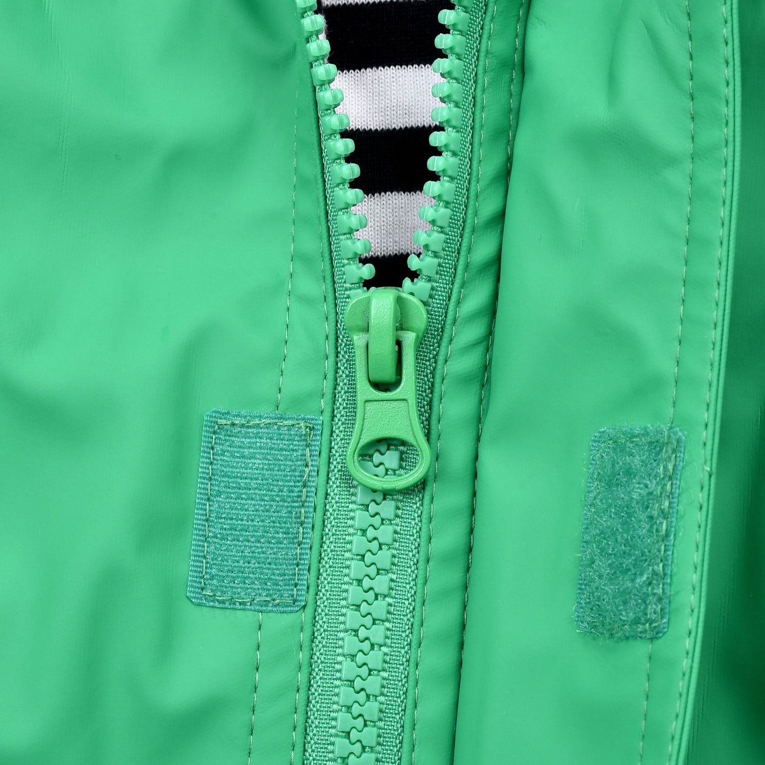 Durable zip on green raincoat